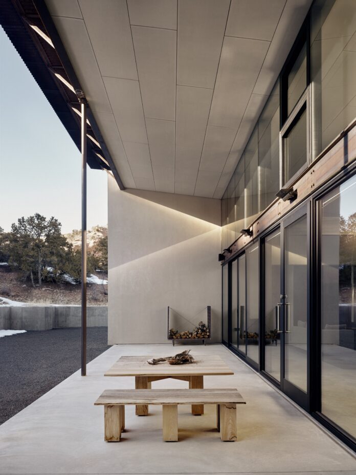 Modernism Rooted 3 modern home white and black outside with wooden table