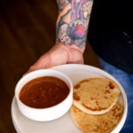 Duck fat tortillas on a white plate with sauce