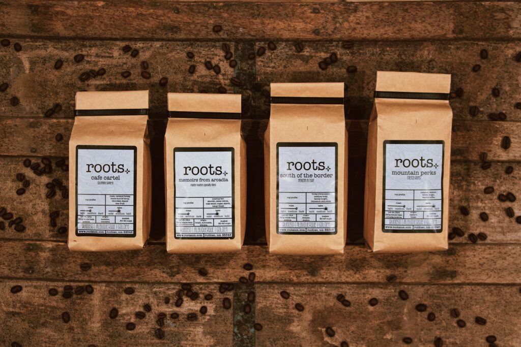 roots ground coffee bags lined up on wooden table
