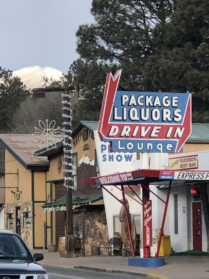 Ruidoso Uncovered 5 old designed bar called win place show with sign in view