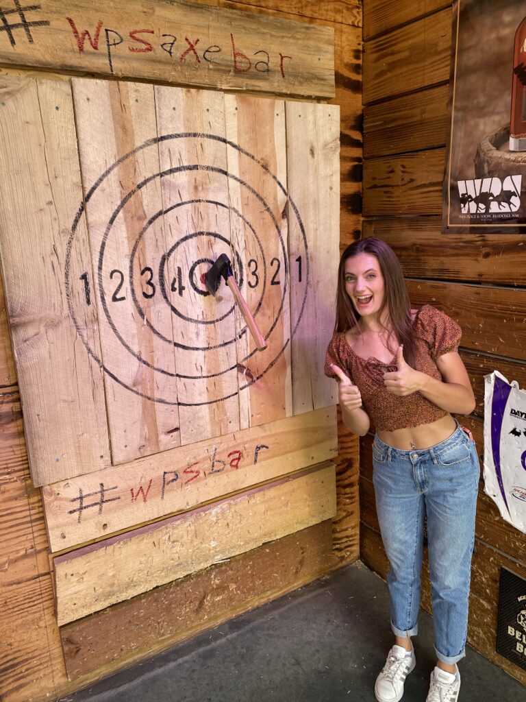 axe in wooden wall at throwing center