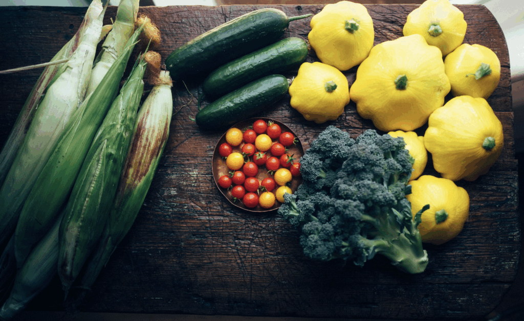 fresh yellow and green produce from jacks garden laid out on table