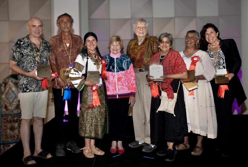 International Folk Art Market 2025 TABLE Magazine 2 A group of people holding awards from the International Folk Art Market 2025.