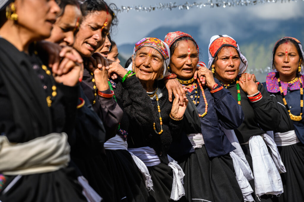 traditional women holding each other in a line at ceremony