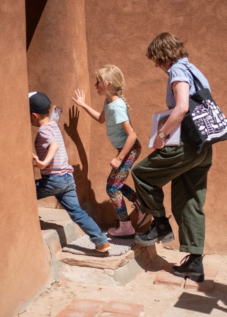 Two kids and a mom walk into an aztec orange home.