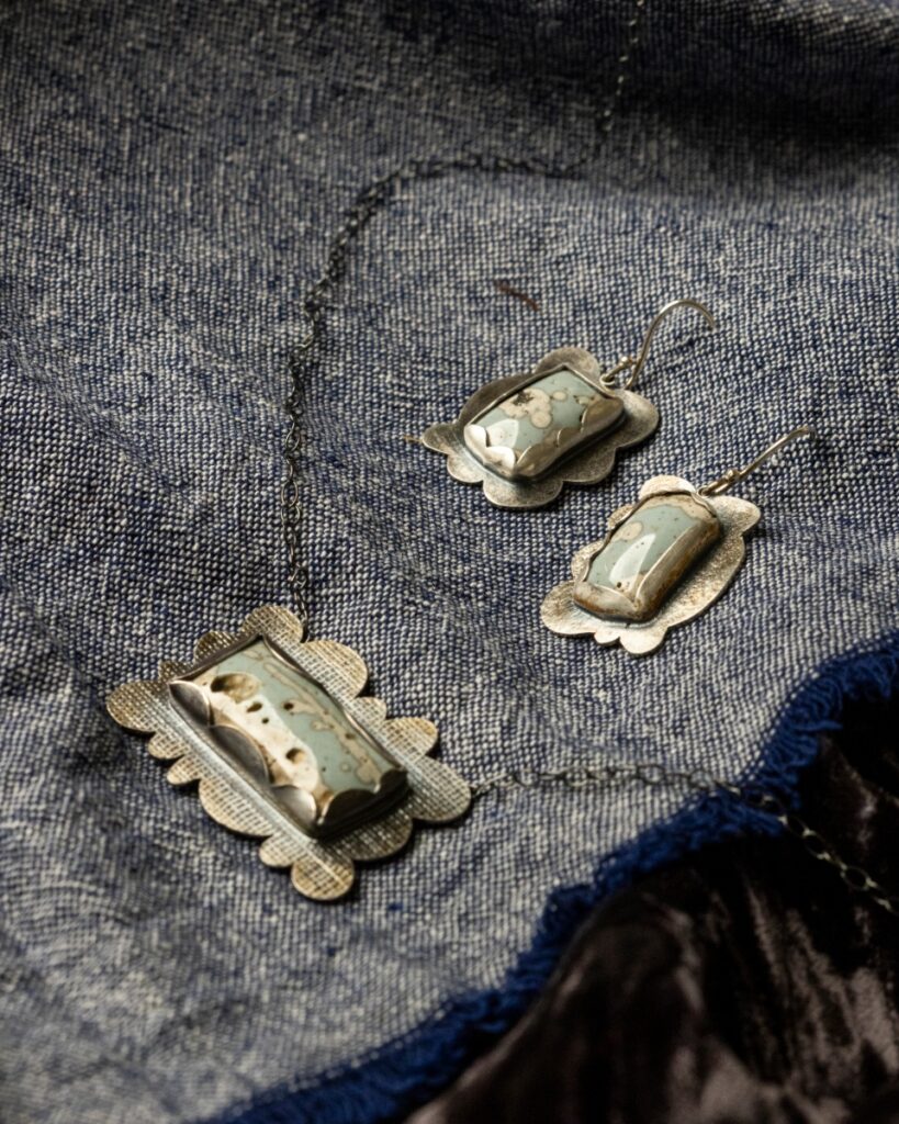 Sterling silver necklace and matching French hook earrings by Marian Miller, set with rectangular pieces of polished turquoise-like slag glass.