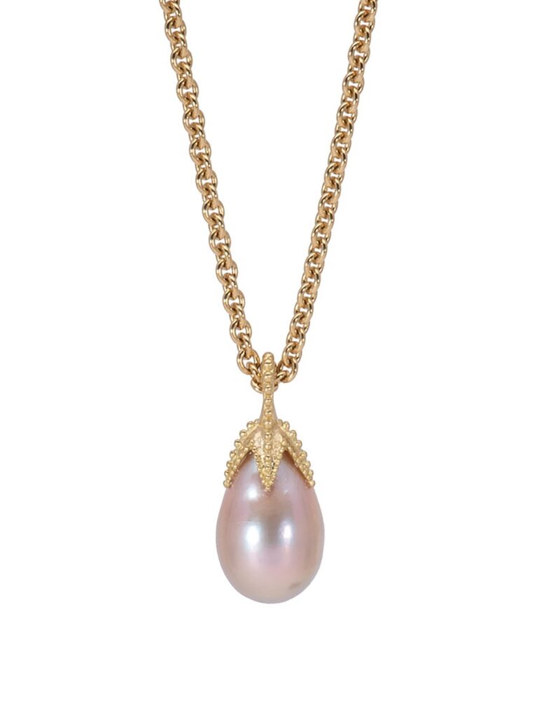 A delicate 18K gold chain with a pink baroque pearl pendant crowned with a gold starfish using the ancient technique of granulation.