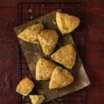 Savory Kale, Cheese, and Cornmeal Scones on a baking sheet.