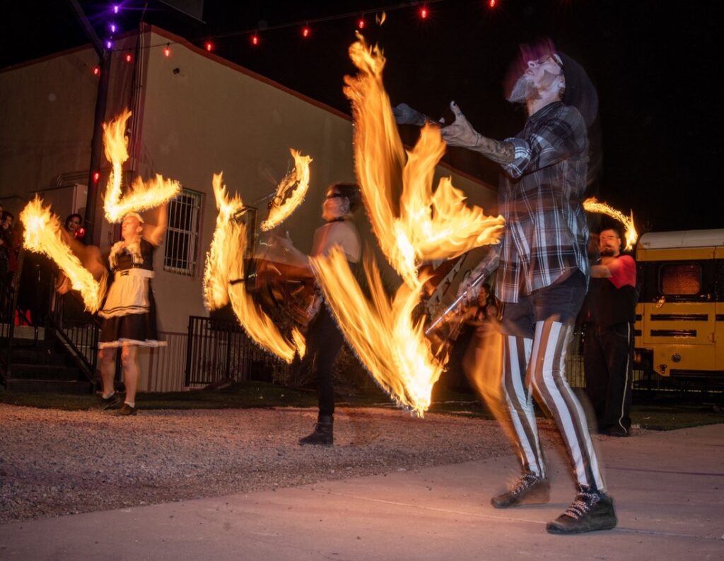People fire juggling outside.