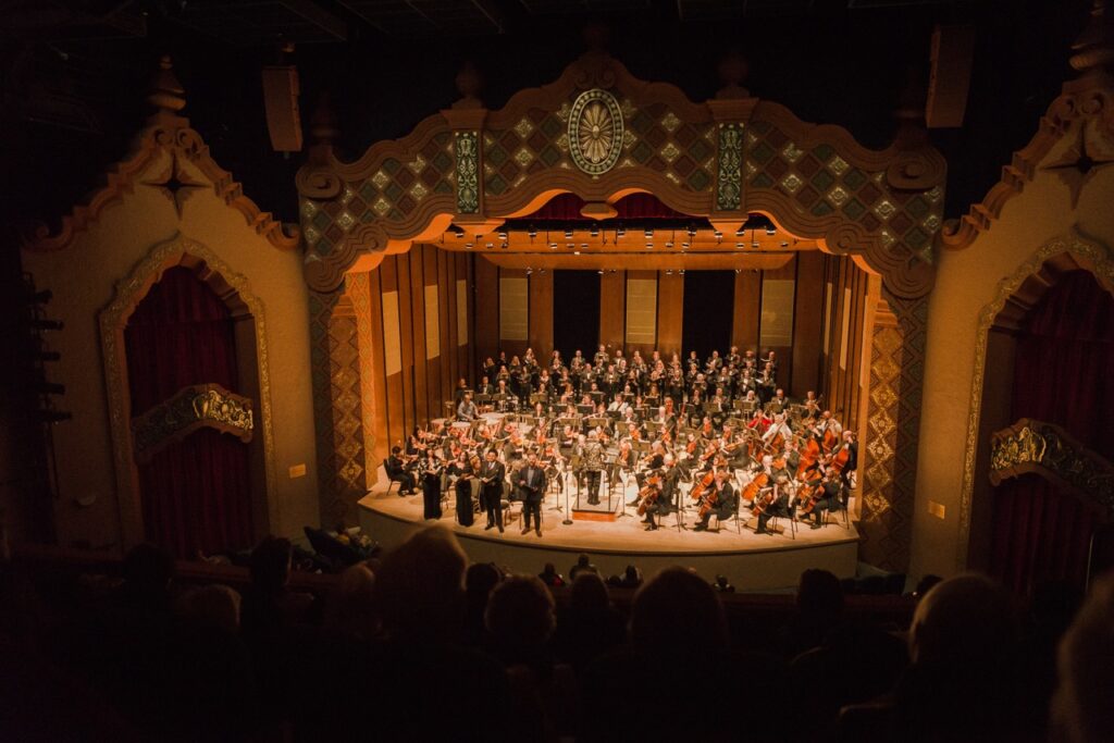The Lensic theater with an orchestra on stage.