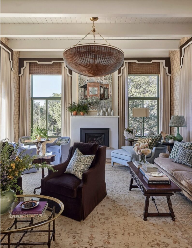 The inside of a living space with chairs, light decor, and plants.