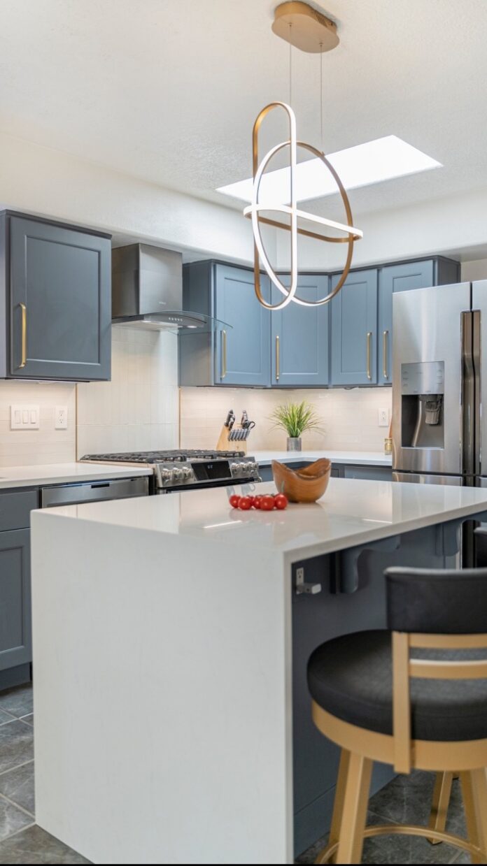 A kitchen space with a white counter and modern wares.