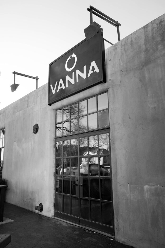 The outside of Vanna Curated Living with a big sign above the door.
