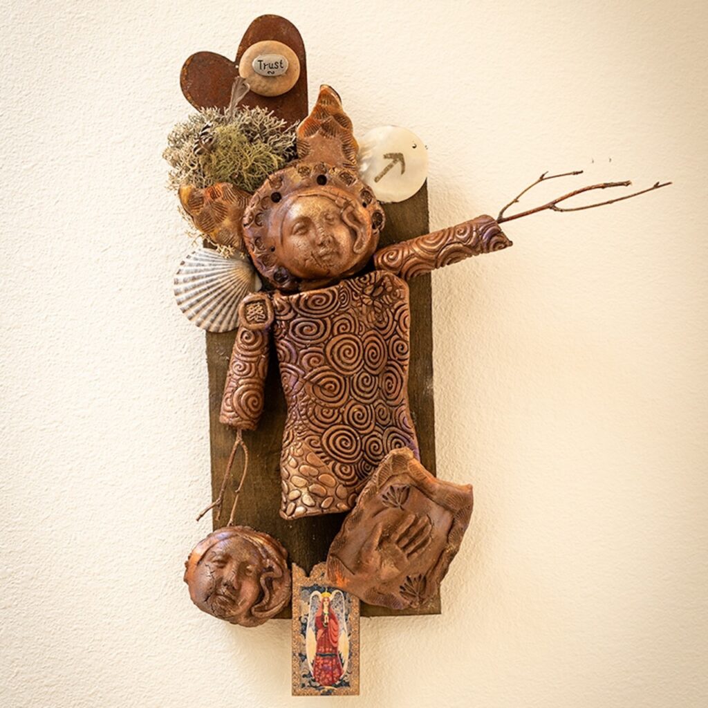 A sculpture in blue of a women's face.