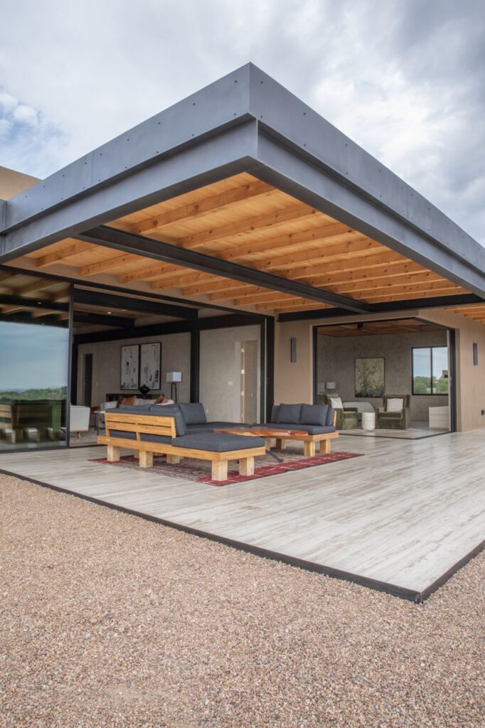 An outside patio with two lounging benches.