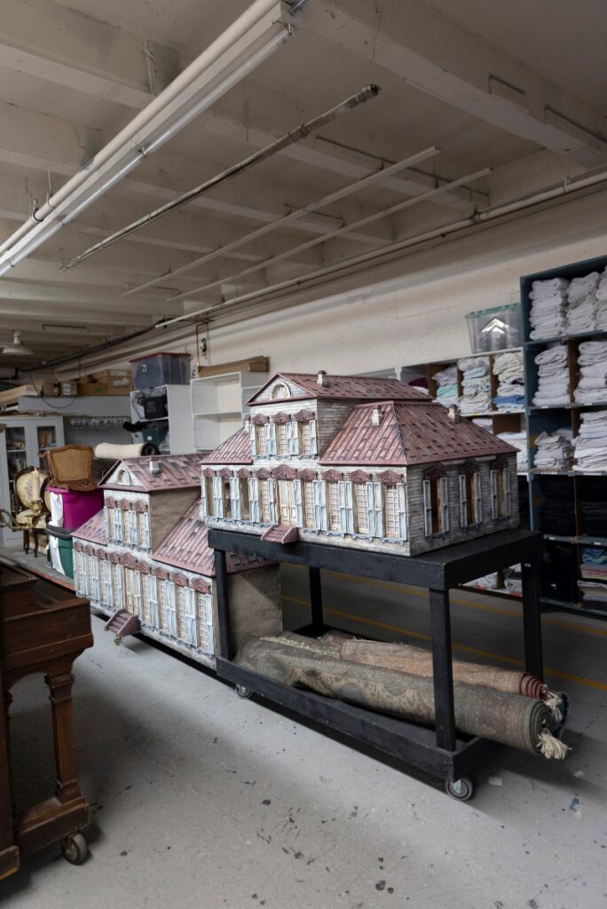 A large architectural scale model of a historic French-style mansion used for set design at the Santa Fe Opera.