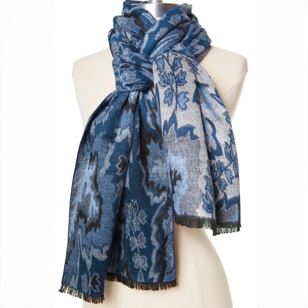 A blue pattern scarf wrapped around a mannequin neck.