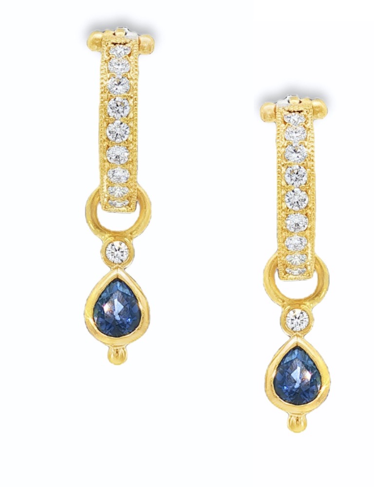 A pair of sapphire and silver earrings that dangle.