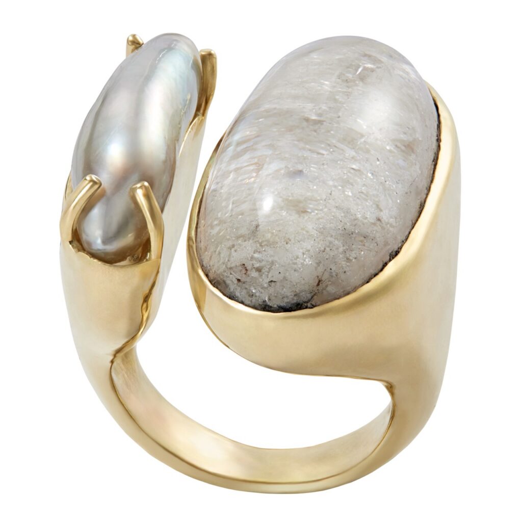 A gold wrap around ring with a grey gemstone.