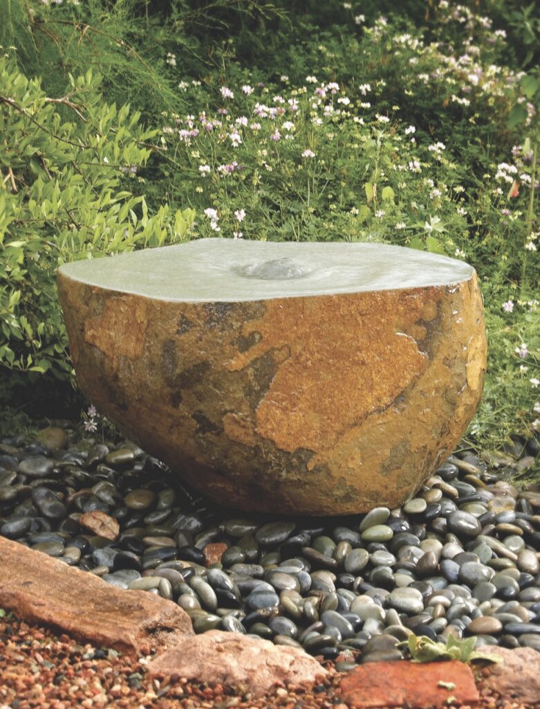 A boulder fountain in an outside space.