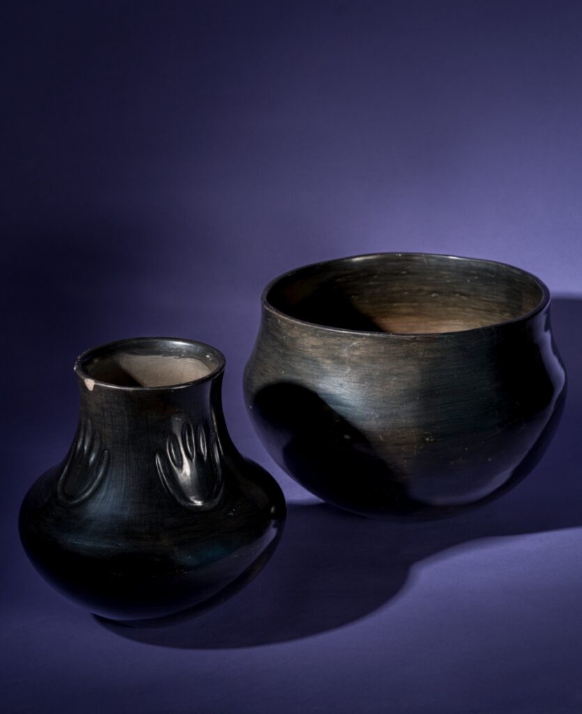 A traditional black polished Santa Clara Pueblo pottery jar created by Severa Tafoya, featuring the iconic deeply indented bear paw design and a high-gloss finish.