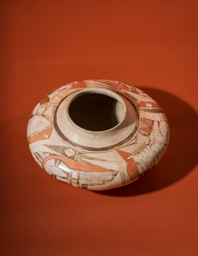 A historic Hopi-Tewa polychrome pottery jar created by Nampeyo circa 1915, featuring intricate abstract line work and geometric designs in traditional clay and paint.