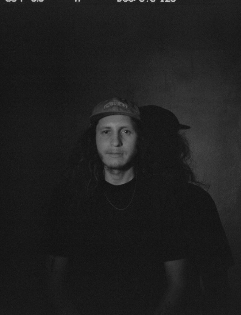 Chef Johnny Ortiz-Concha, creator of Juliette restaurant at Hotel Willa, leaning against a minimalist white wall.