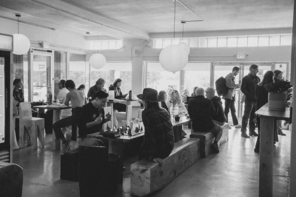 Customers enjoying coffee and playing chess inside the airy Tomorrow and Tomorrow.