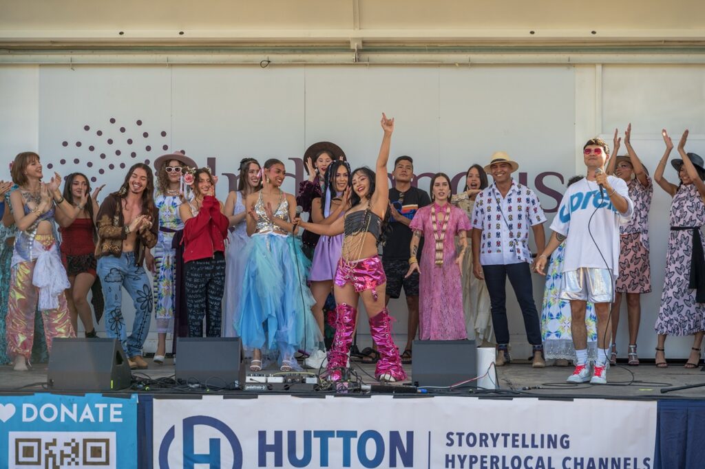 A group of Native Americans celebrate on a stage.