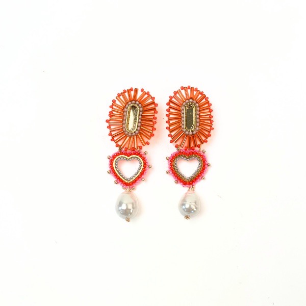 Two orange and silver and green earrings with small heart charms.