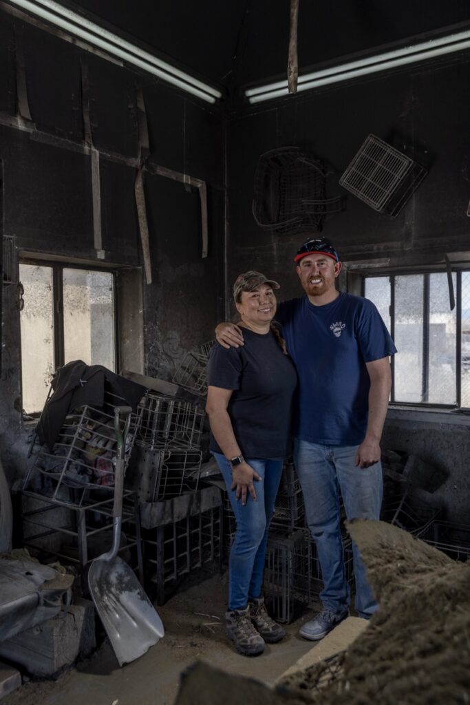 Chris Youngblood and Jennifer Tafoya stand together in their ceramics hut.