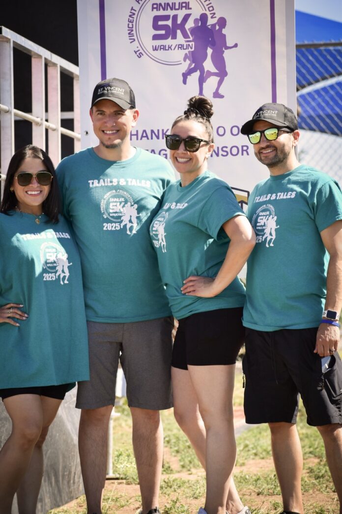 Marcos Zubia St Vincent Hospital Foundation TABLE Magazine Four people from St Vincent Hospital Foundation in blue shirts for a foundation run.
