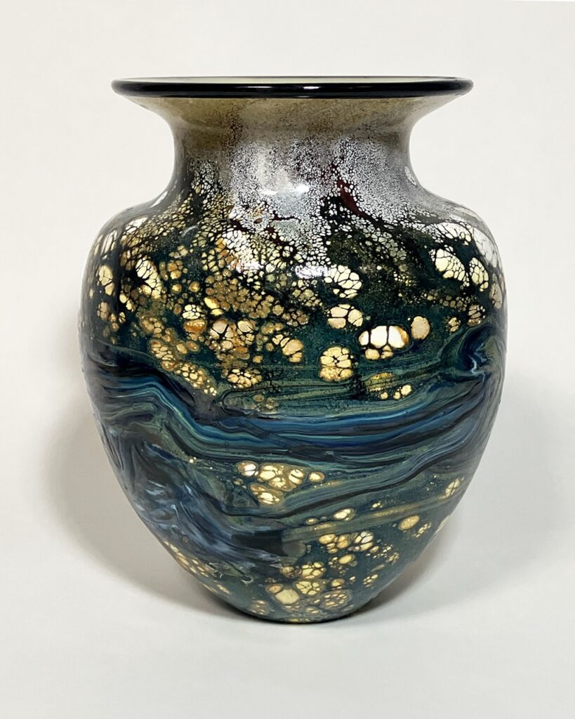 A vase with blue waves and gold speckling.