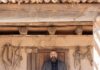 Take a Visit to El Rancho de las Golondrinas A man stands outside a historic building in El Rancho de las Golondrinas.
