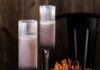 High Desert Spritz With Gin & Prosecco Two tall cocktail flutes with a High Desert Spritz inside with a purple color and a bowl of pretzel sticks beside the cocktails.