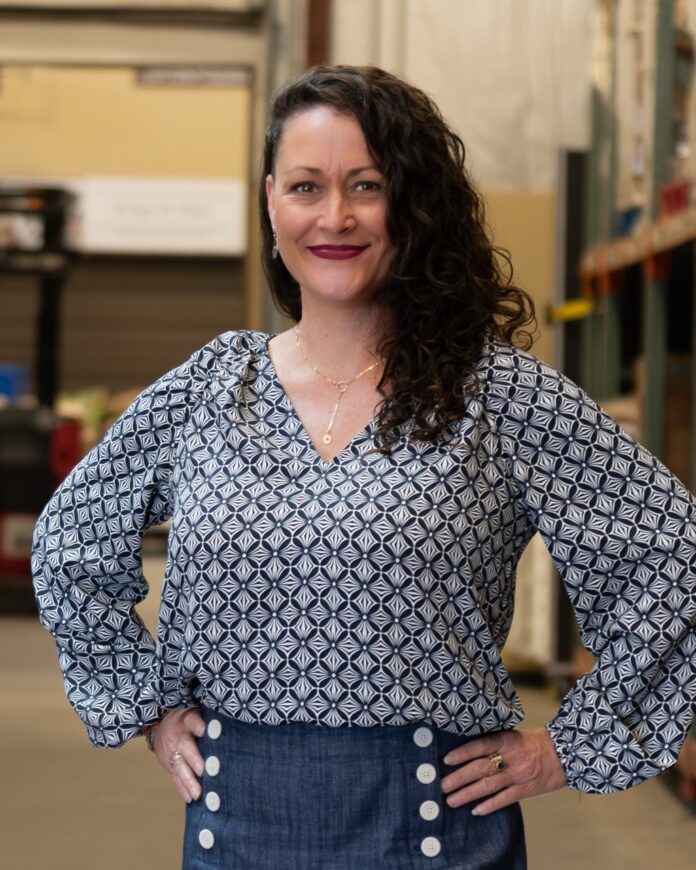 Jill Dixon The Food Depot New Mexico TABLE Magazine Jill Dixon stands in a long sleeve shirt in The Food Depot warehouse.