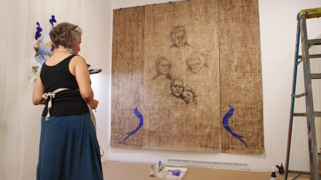 A women working on a painting.