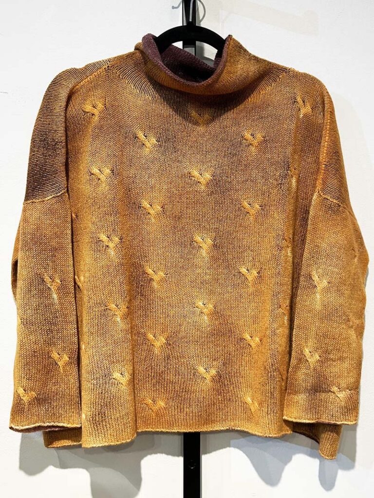 A sweater in browns, yellows, and oranges.