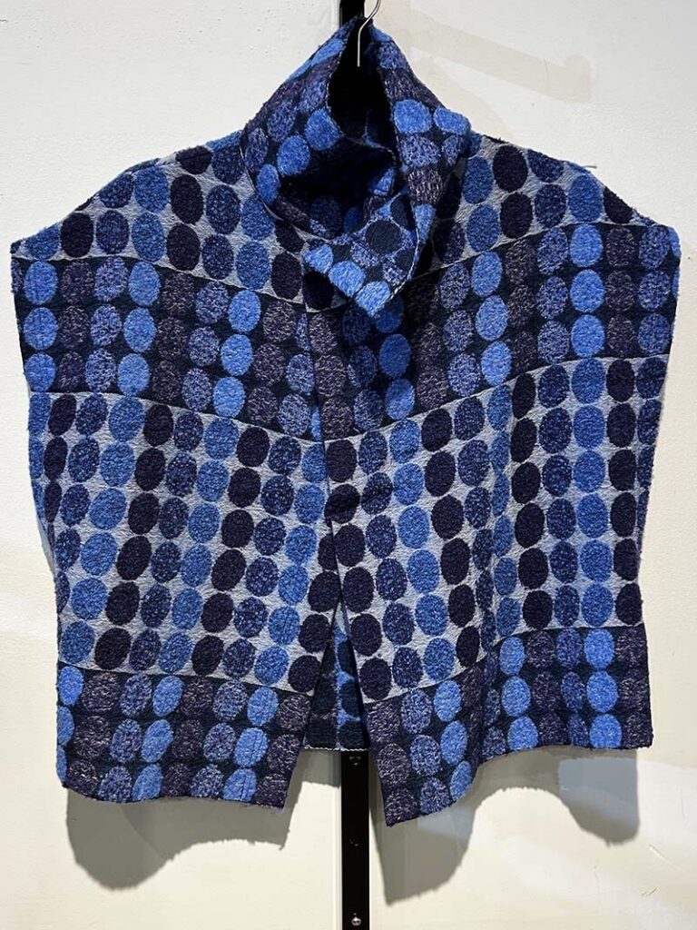 A blue polka dot vest in various tones of blue.