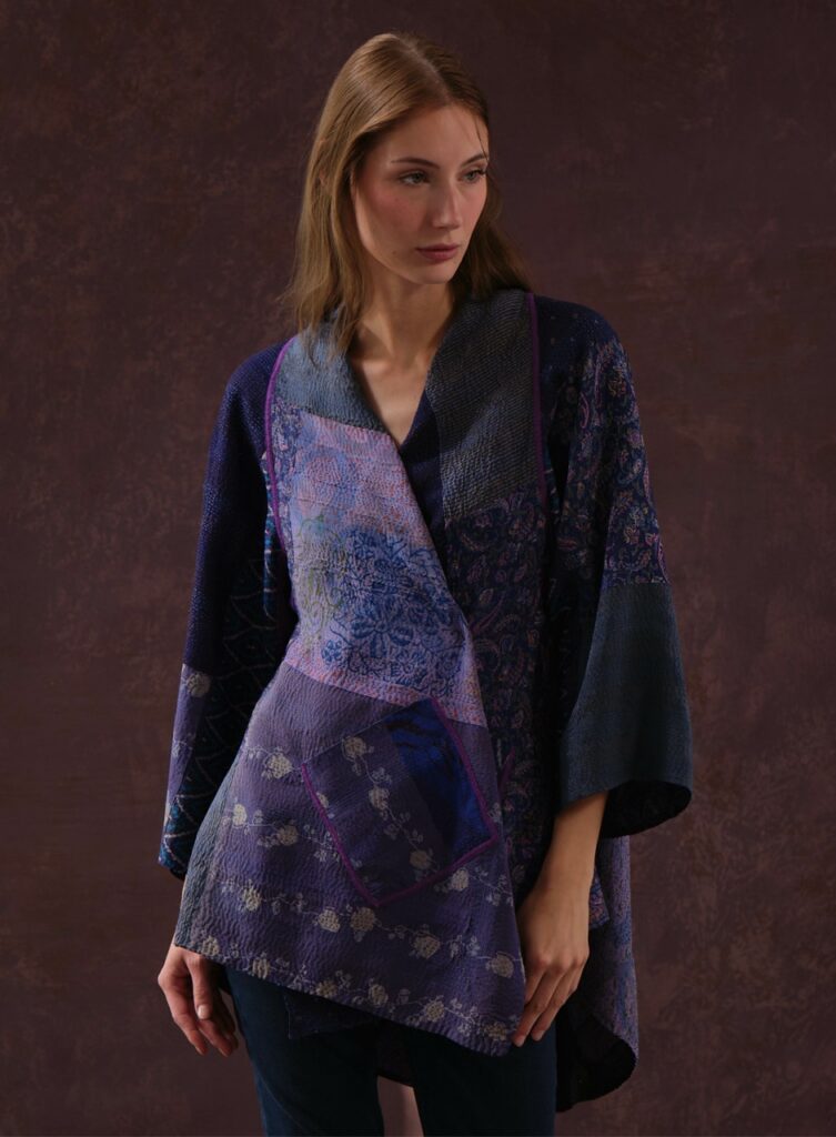 A woman in a blue kimono esc coat with patterns.
