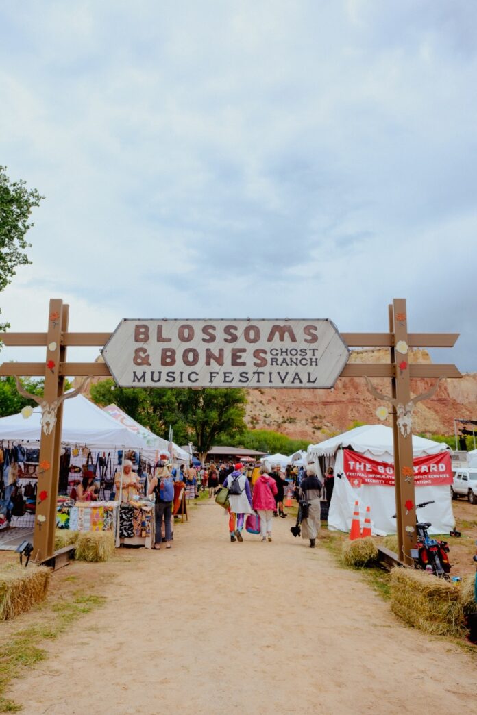 Wooden entrance archway welcoming visitors to the Blossoms & Bones Ghost Ranch Music Festival in Abiquiú, New Mexico.