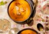 Carrot and Ginger Soup With Seared Scallops Creamy orange carrot and ginger soup topped with golden-seared scallops, chive oil, and pink peppercorns, served in dark bowls alongside glasses of white wine and a bottle of Tablas Creek Esprit de Tablas Blanc.