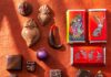 The Best Local Chocolate & Coffee Brands to Try in New Mexico Various pieces of chocolate on an orange background with chocolate bark and little bars.