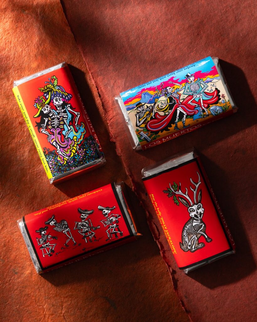 Four mini chocolate bars on an orange background.