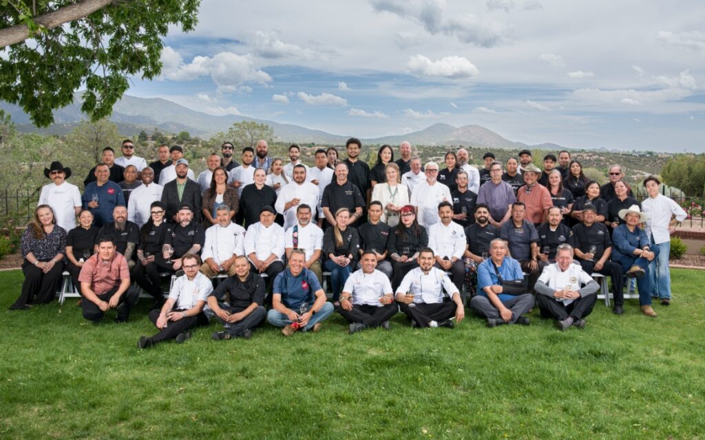 Participating chefs posing together for a group photo on the Governor’s Mansion lawn during the Santa Fe Wine & Chile Fiesta.