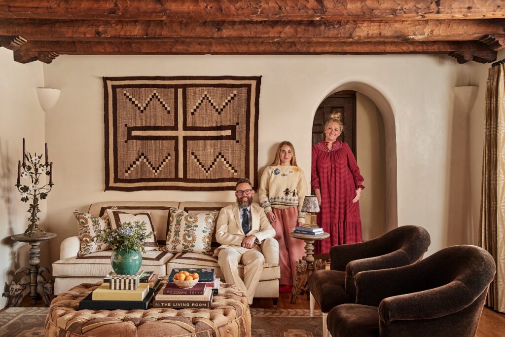 Interior designer Heather French, her husband Matt French, and their family posing together inside the light-filled living room of the restored Applegate Estate.
