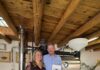 The Charm of Wolf & Mermaid Enchanted Café in New Mexico The owners of Wolf and Mermaid Enchanted Cafe stand side by side in the cafe space, holding an award in the man's hand.