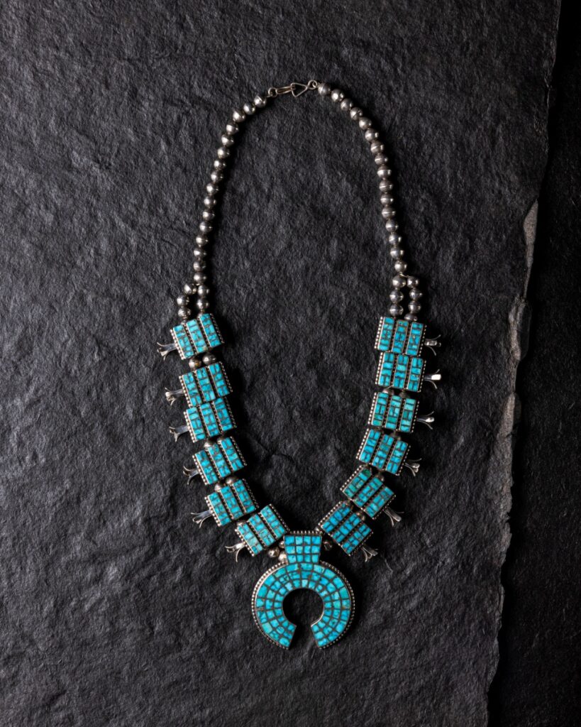 Zuni silver squash blossom necklace set with Blue Gem turquoise channel inlay.