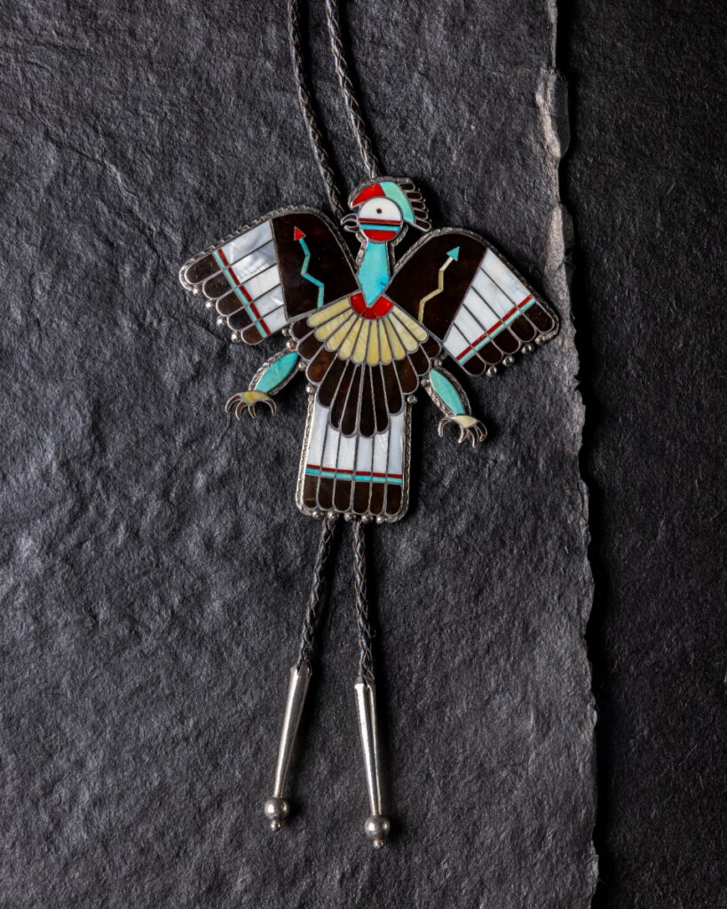Zuni bolo tie by Owen Bobelu featuring an inlaid mother-of-pearl thunderbird motif.