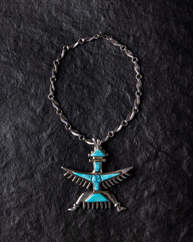 Cast silver pendant necklace by Juan de Dios featuring a Zuni Knifewing deity set with turquoise.
